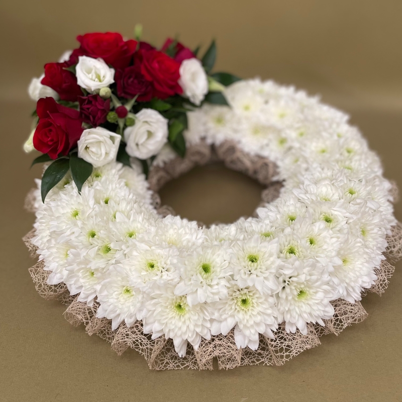 Based wreath with natural ribbon