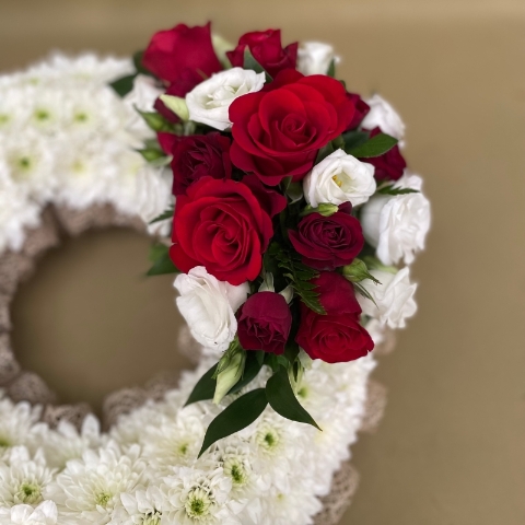 Based wreath with natural ribbon