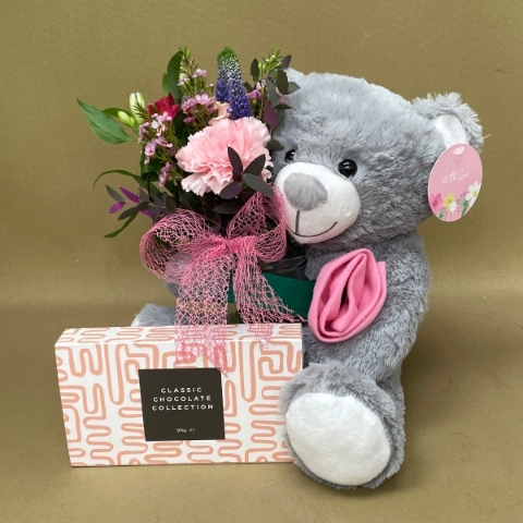 Summer garden bear with flowers and chocolates